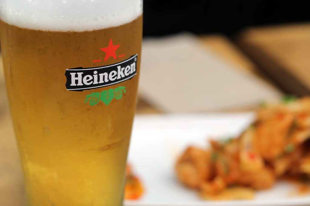 Chilled Heineken beer with a side of delicious snacks on a sunny day.